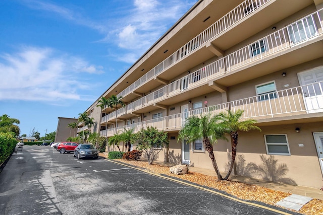 2300 NE 1st Ln Unit 307, Boynton Beach, FL 33435 - view of apartment building / complex featuring uncovered parking