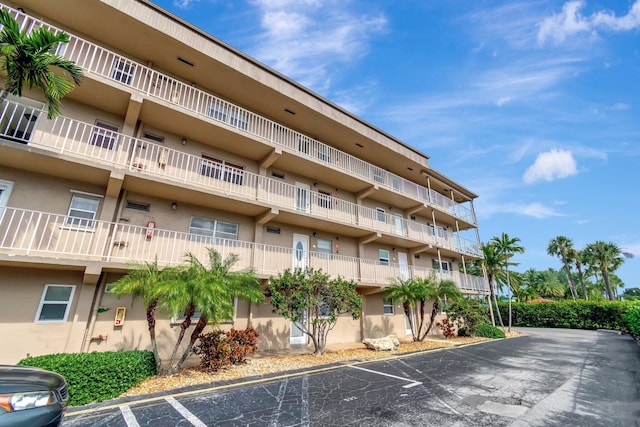 2300 NE 1st Ln Unit 307, Boynton Beach, FL 33435 - view of apartment building / complex featuring uncovered parking