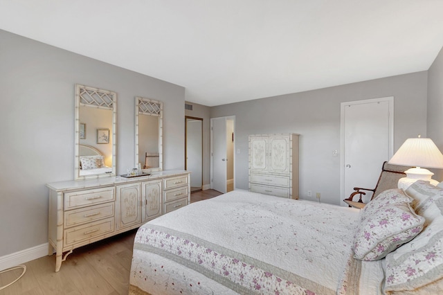 2300 NE 1st Ln Unit 307, Boynton Beach, FL 33435 - bedroom featuring light wood-style flooring and baseboards