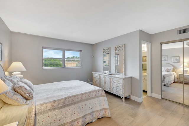 2300 NE 1st Ln Unit 307, Boynton Beach, FL 33435 - bedroom featuring light wood-type flooring, a closet, and baseboards
