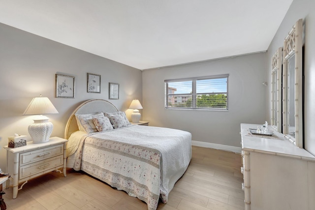 2300 NE 1st Ln Unit 307, Boynton Beach, FL 33435 - bedroom with baseboards and light wood-type flooring