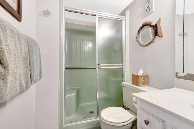 2300 NE 1st Ln Unit 307, Boynton Beach, FL 33435 - bathroom featuring vanity, a shower stall, and toilet
