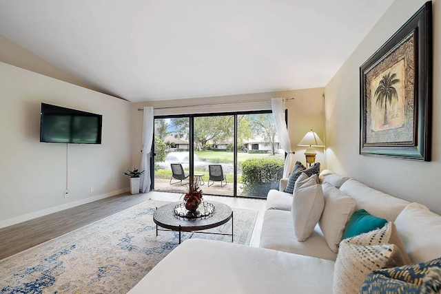 living room featuring hardwood / wood-style floors and lofted ceiling