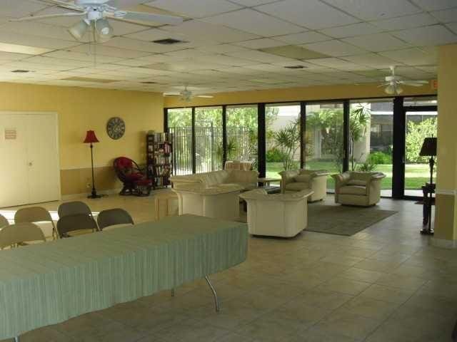 interior space featuring a paneled ceiling and a healthy amount of sunlight