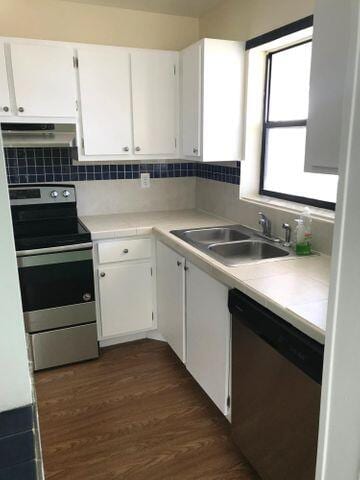 kitchen with sink, white cabinets, extractor fan, and appliances with stainless steel finishes