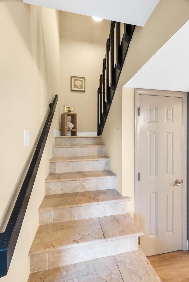 stairway with hardwood / wood-style floors