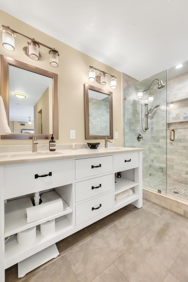 bathroom with tile patterned flooring, vanity, and walk in shower