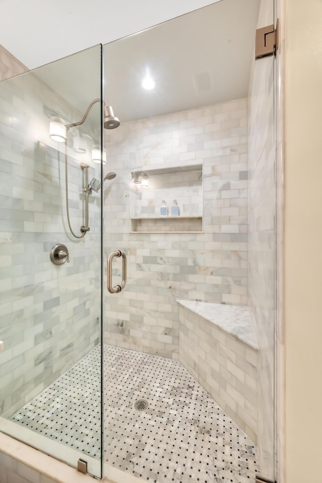 bathroom with a shower with shower door