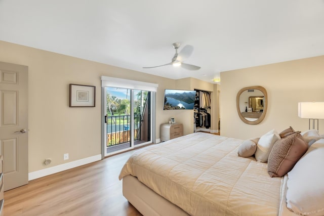 bedroom featuring hardwood / wood-style floors, access to outside, and ceiling fan