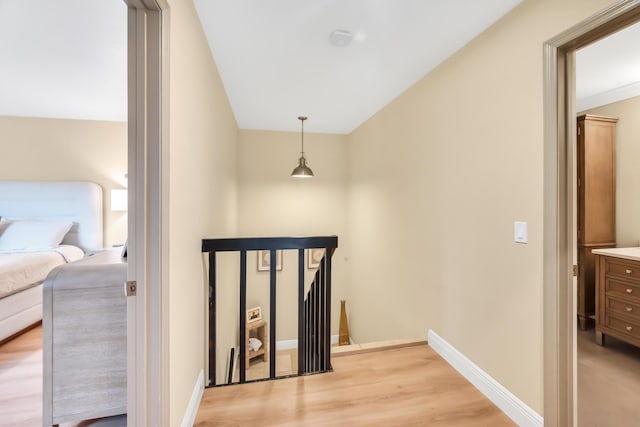 hallway with light hardwood / wood-style flooring