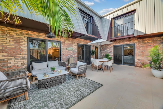 view of patio with a balcony and an outdoor hangout area