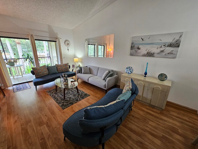 living room with high vaulted ceiling, a textured ceiling, and hardwood / wood-style flooring