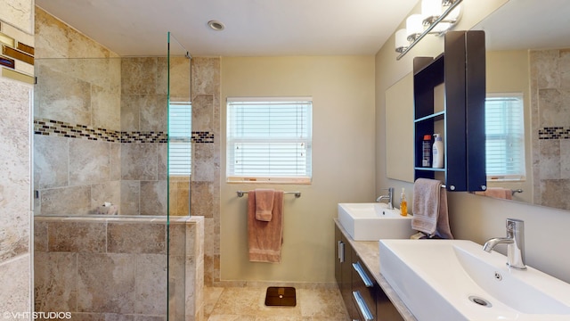 bathroom featuring a tile shower and vanity