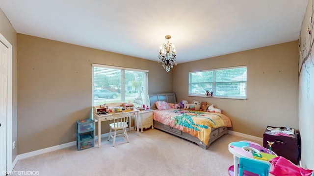 carpeted bedroom featuring an inviting chandelier