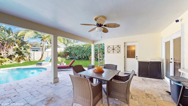 view of patio / terrace featuring a fenced in pool and ceiling fan