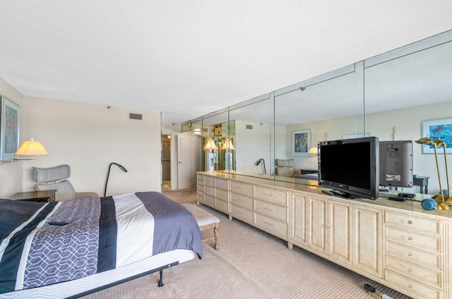 bedroom featuring light carpet