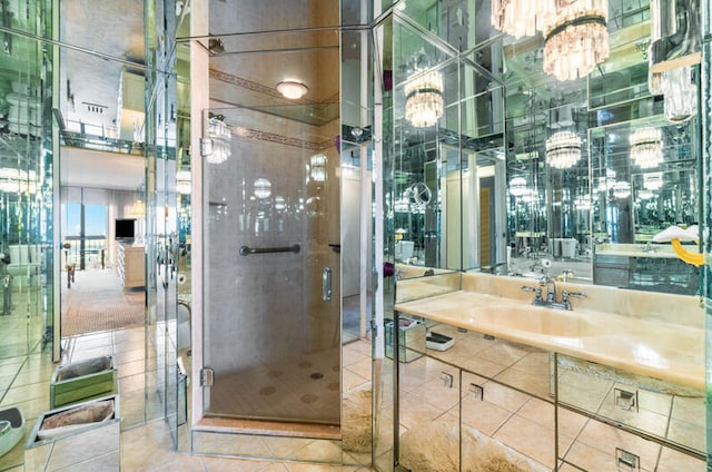 bathroom featuring tile patterned flooring, an enclosed shower, and sink