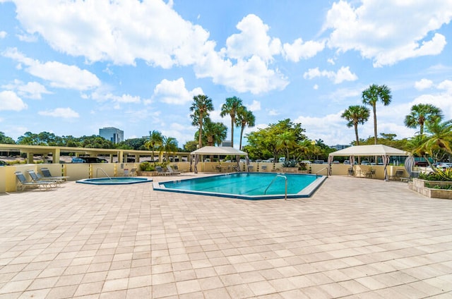 view of swimming pool featuring a patio area and a community hot tub