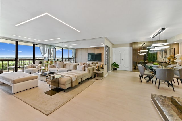 living room featuring wood-type flooring and expansive windows