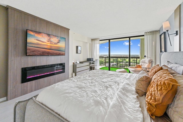 bedroom with access to exterior and expansive windows