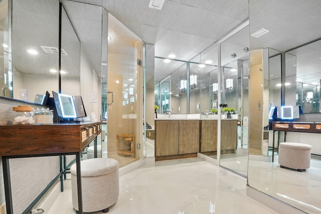 bathroom featuring vanity, an enclosed shower, and concrete floors