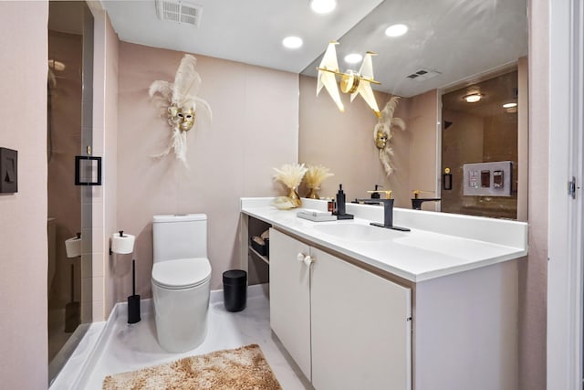 bathroom featuring vanity, an inviting chandelier, toilet, and a shower with door