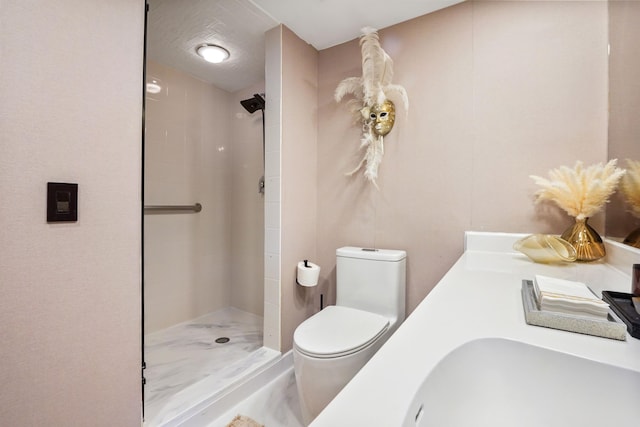 bathroom featuring toilet, sink, and a tile shower