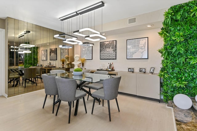 dining space with light hardwood / wood-style flooring