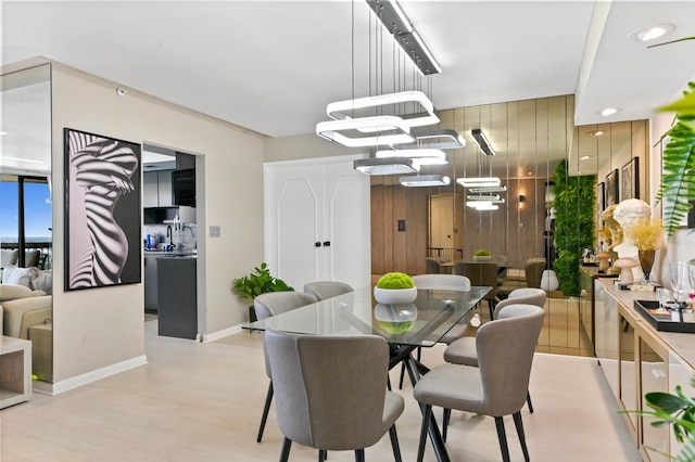 dining space featuring a notable chandelier and light hardwood / wood-style floors