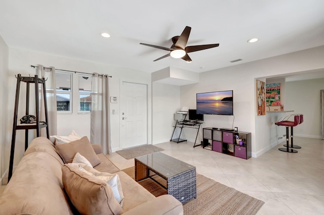 living room featuring ceiling fan and light tile patterned flooring