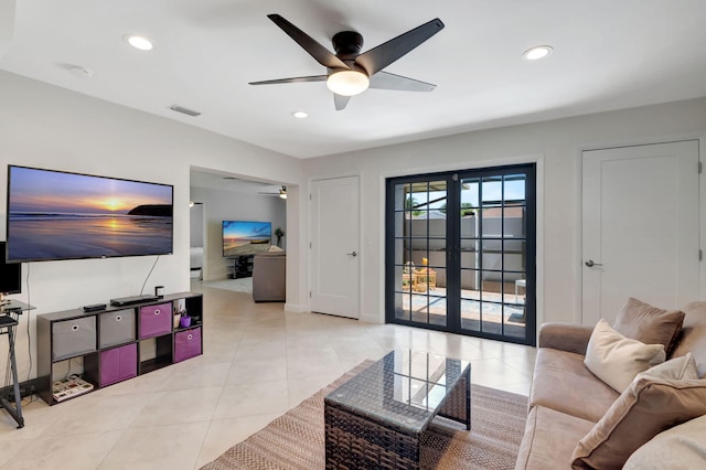 tiled living room with french doors and ceiling fan