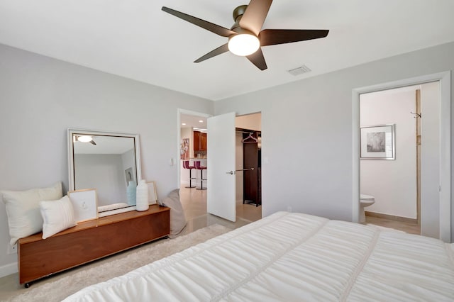 bedroom with connected bathroom, a spacious closet, a closet, and ceiling fan