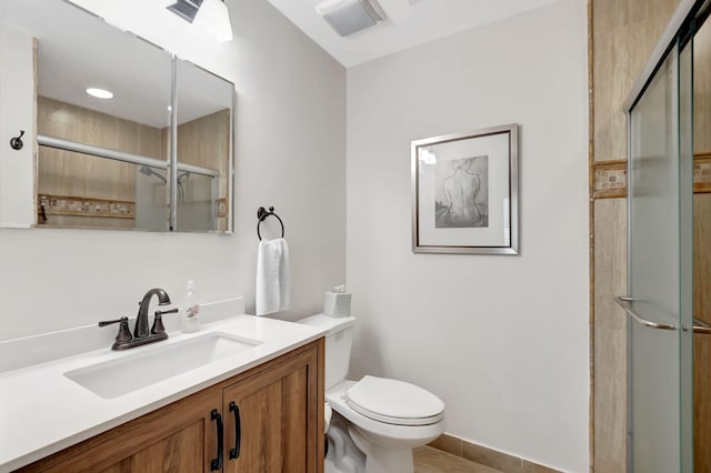 bathroom with tile patterned flooring, vanity, toilet, and a shower with shower door