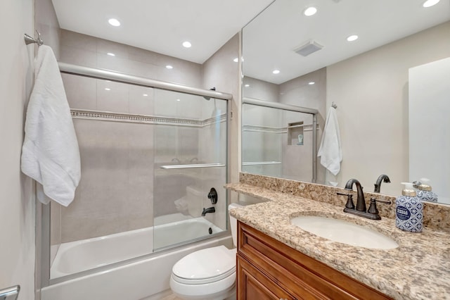 full bathroom with vanity, toilet, and enclosed tub / shower combo