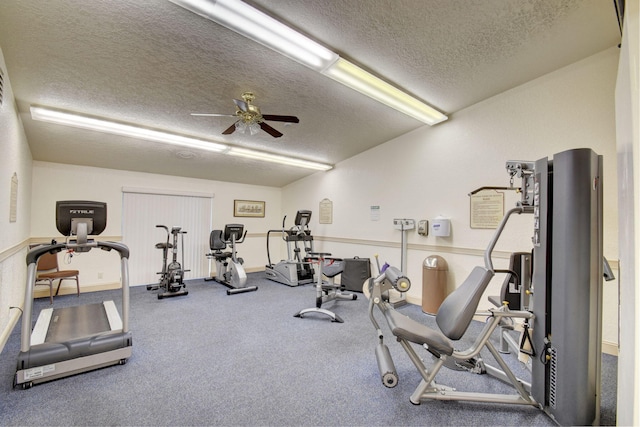 gym featuring ceiling fan and a textured ceiling