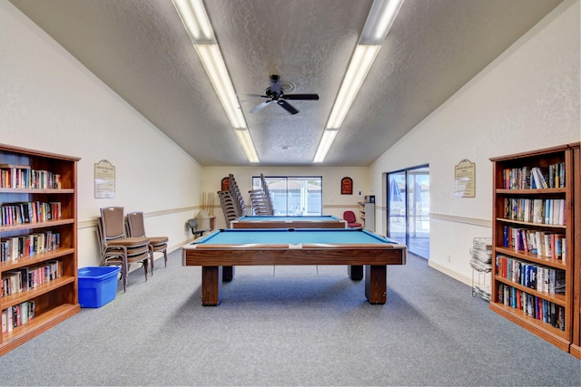 game room featuring carpet flooring, a textured ceiling, vaulted ceiling, ceiling fan, and billiards