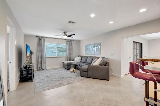 living room with ceiling fan and light tile patterned floors