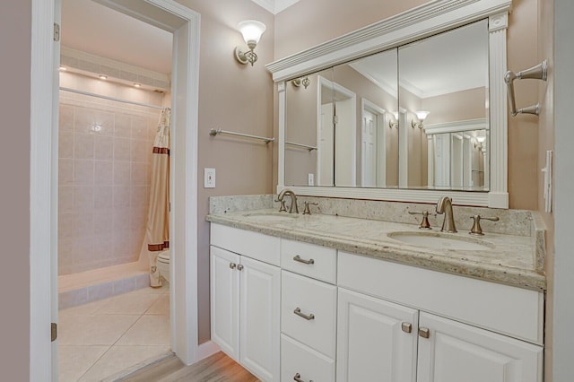 bathroom featuring hardwood / wood-style flooring, a shower with curtain, ornamental molding, and vanity