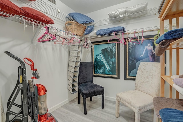 spacious closet featuring hardwood / wood-style flooring