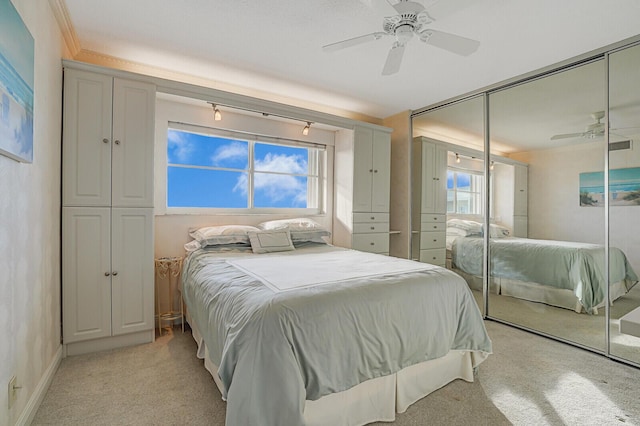 bedroom featuring ceiling fan and light colored carpet