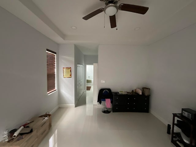 interior space with ceiling fan