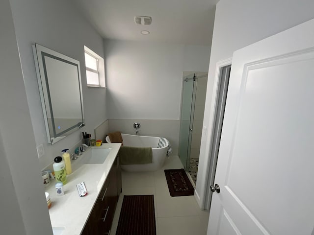 bathroom featuring tile patterned flooring, vanity, and shower with separate bathtub