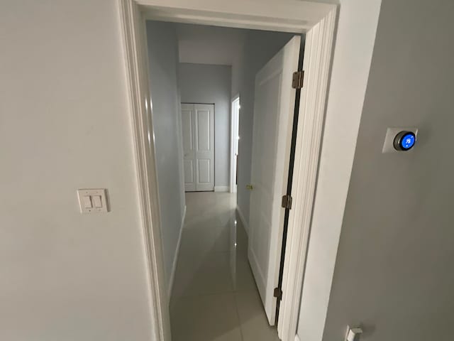 corridor featuring light tile patterned flooring