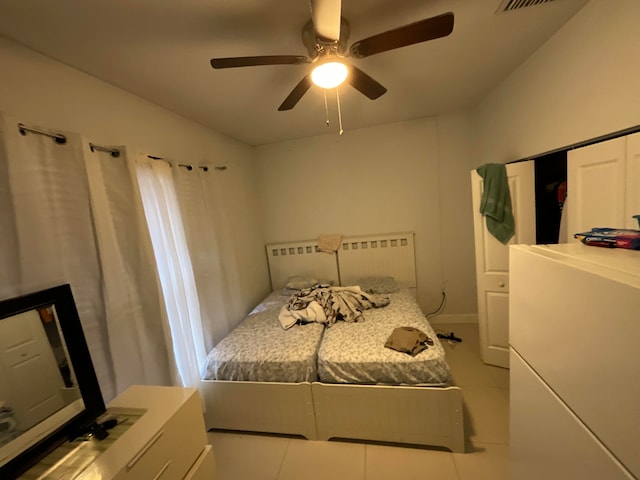 tiled bedroom with ceiling fan