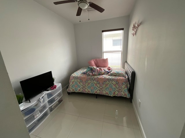 bedroom with ceiling fan and light tile patterned floors