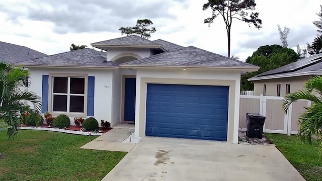 view of front of home featuring a garage and a front lawn