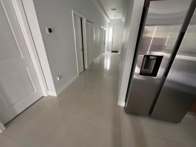 hall featuring light tile patterned flooring