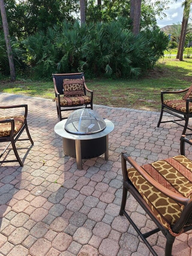 view of patio / terrace featuring an outdoor fire pit