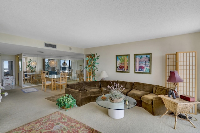 living room featuring carpet and a textured ceiling