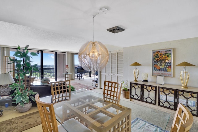 dining space with floor to ceiling windows, carpet, and an inviting chandelier